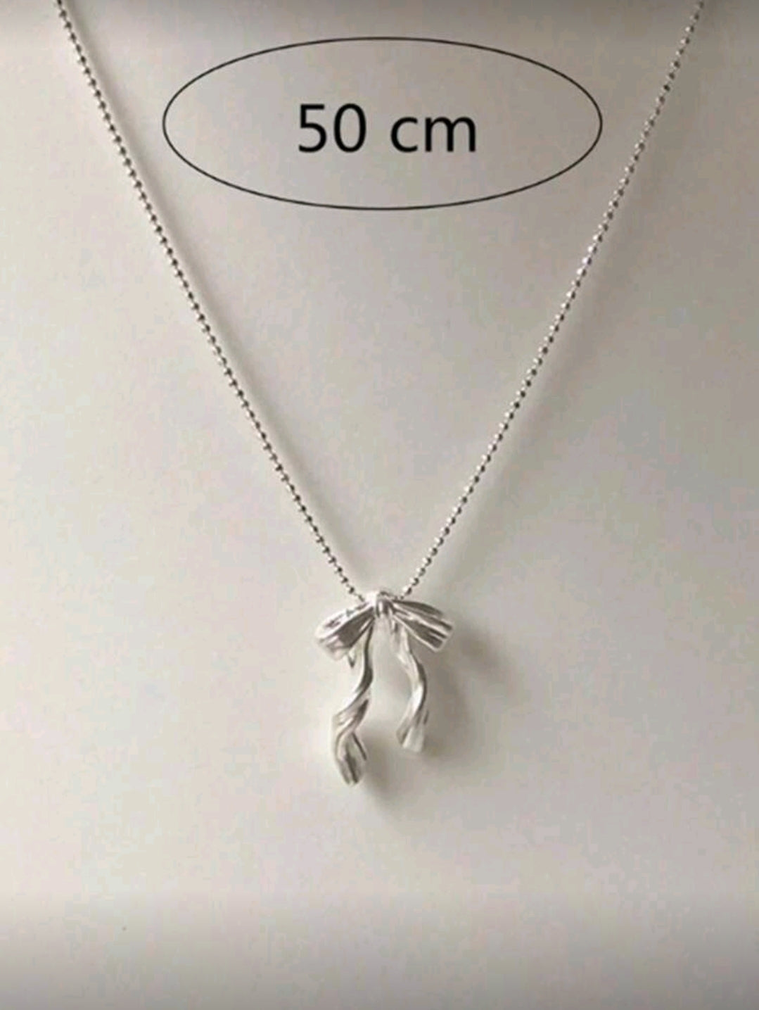 Silver bow necklace