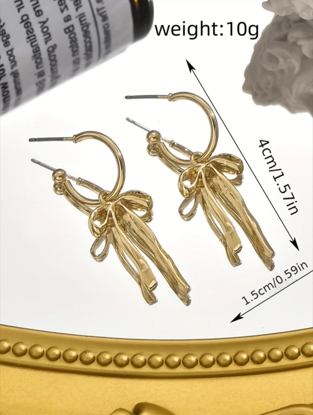 Bow detail golden earrings