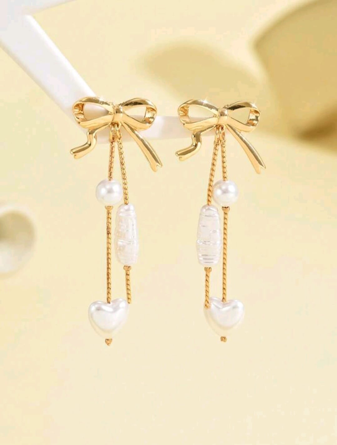 White and golden bow earrings